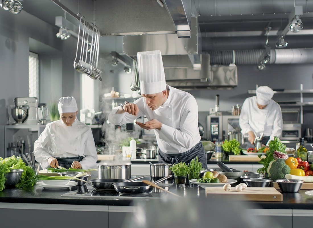 Insurance by industry - Group of Professional Chefs Prepare, Cook, and Taste Test the Food in the Kitchen