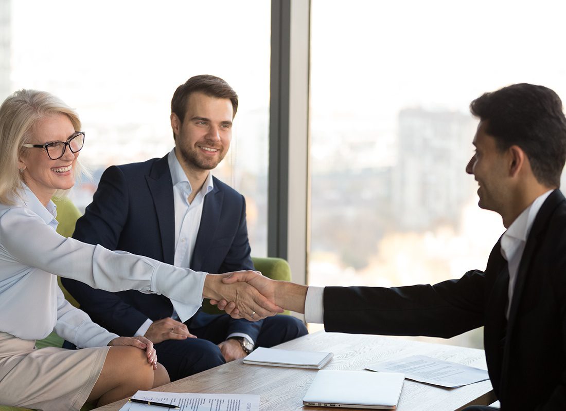 About Our Agency - Agent and Professional Couple Shake Hands at an Office